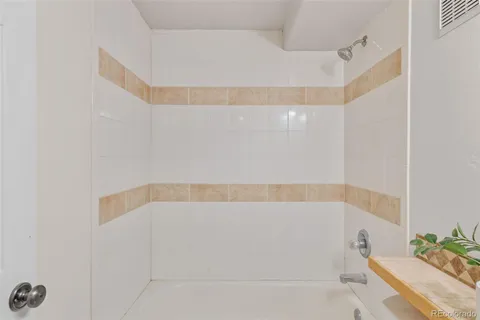 a bathroom with a bathtub and shower