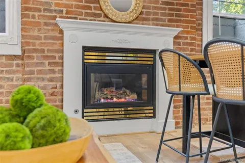 a living room with a fireplace and a rug