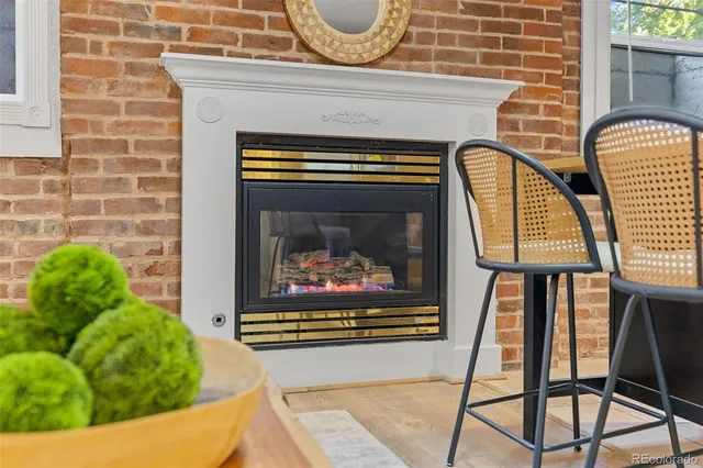 a living room with a fireplace and a rug