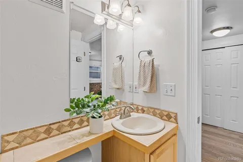 a bathroom with a sink a vanity and a mirror
