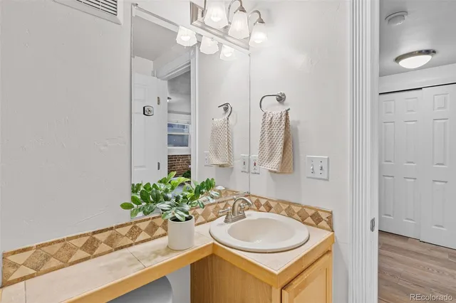 a bathroom with a sink a vanity and a mirror