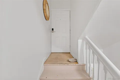 a view of a room with wooden floor and windows
