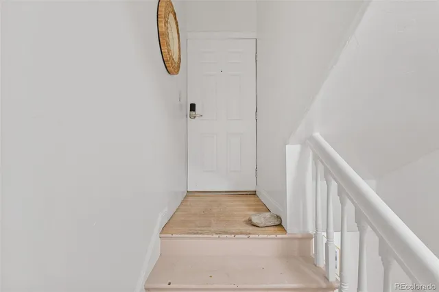 a view of a room with wooden floor and windows