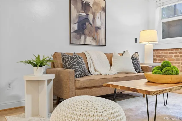 a living room with furniture and a potted plant