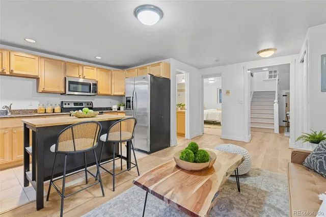 a kitchen with a table chairs refrigerator and microwave