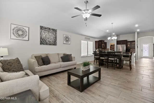 a living room with furniture and kitchen view