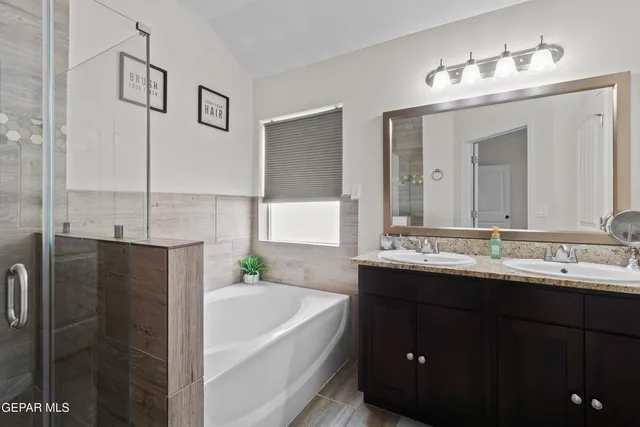 a bathroom with a double vanity sink and mirror