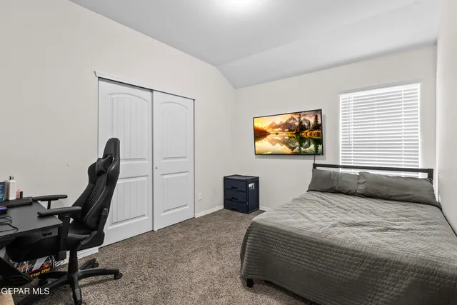 a bedroom with a bed and a desk
