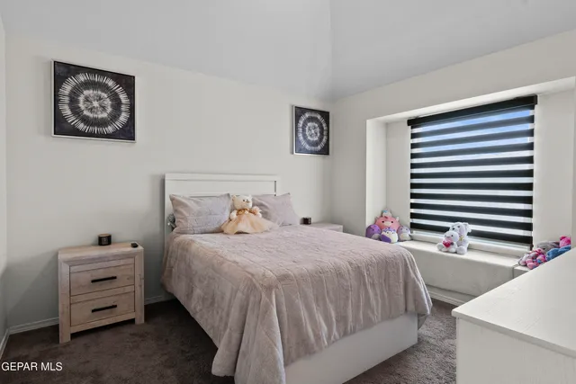 a bedroom with a bed and a desk