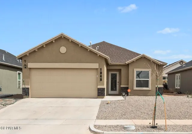 a front view of a house with a garage