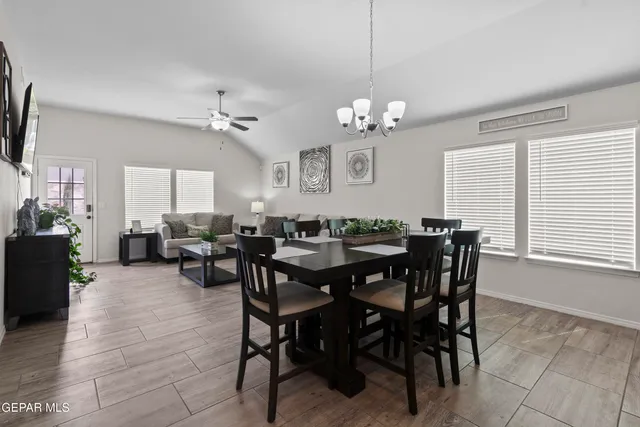 a view of a dining room with furniture and chandelier