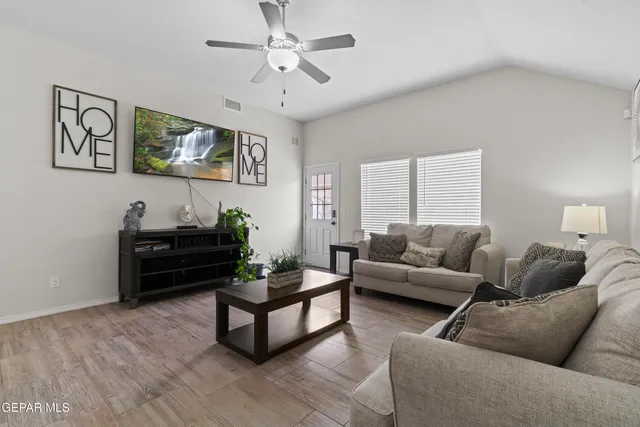 a living room with furniture a rug and a window