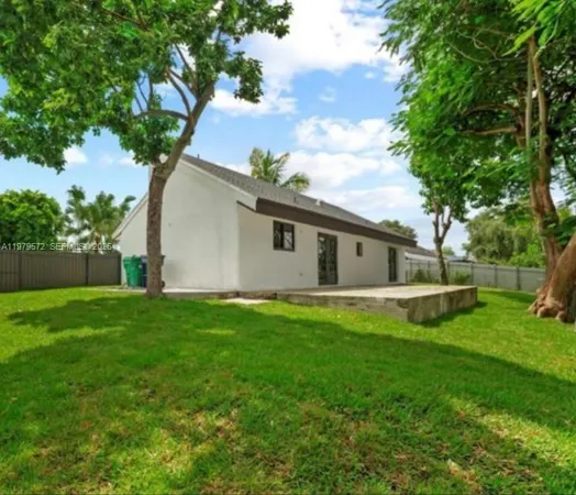 a view of a backyard with plants and a garden
