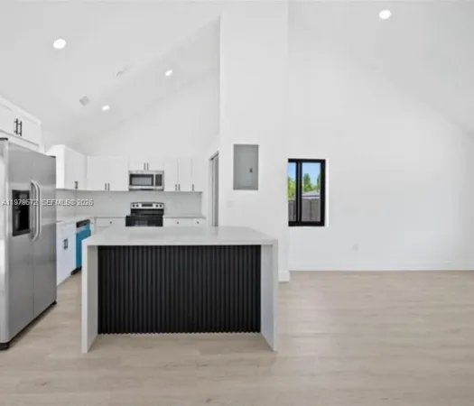 a kitchen with stainless steel appliances a refrigerator and a stove top oven