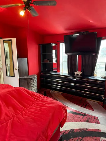 a bed room with a bed vanity and mirror