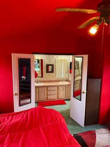 a view of an empty room with wooden floor and windows