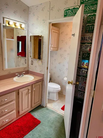 a spacious bathroom with a sink a toilet and shower