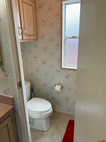 a white toilet sitting next to a small sink
