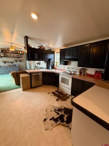 a kitchen that has a sink and a stove in it