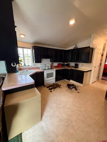 a kitchen with a sink a stove and a refrigerator