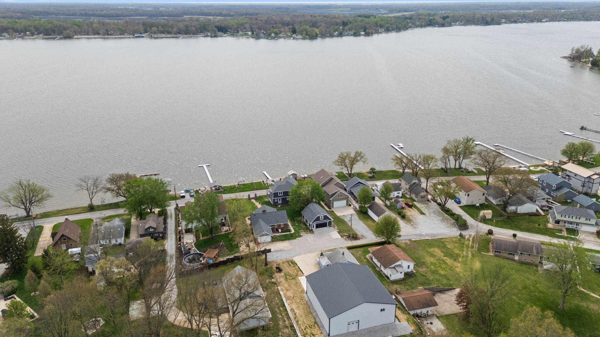 5590 East Maple Street Knox, IN 46534 - Photo 3 of 32 an aerial view of residential houses with outdoor space and lake view
