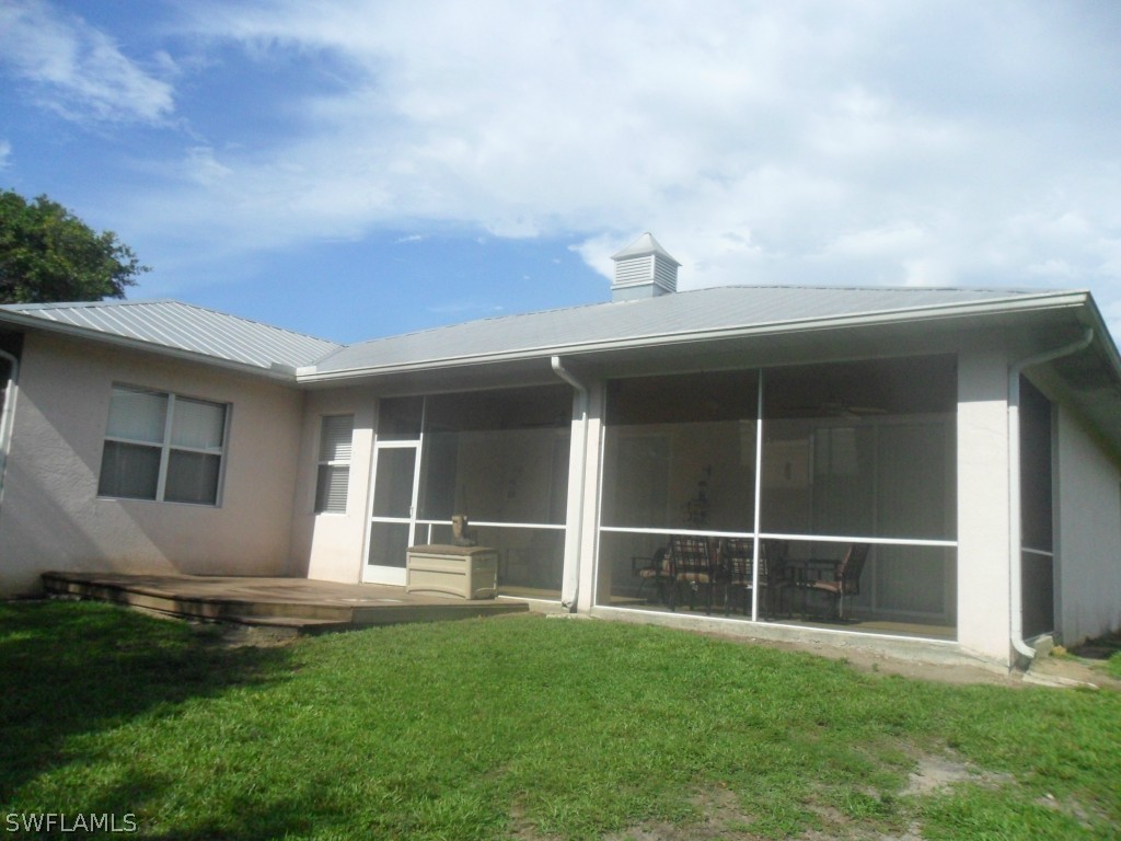 18000 Persimmon Ridge Road Alva, FL 33920 - Photo 3 of 25 a backyard of a house with table and chairs