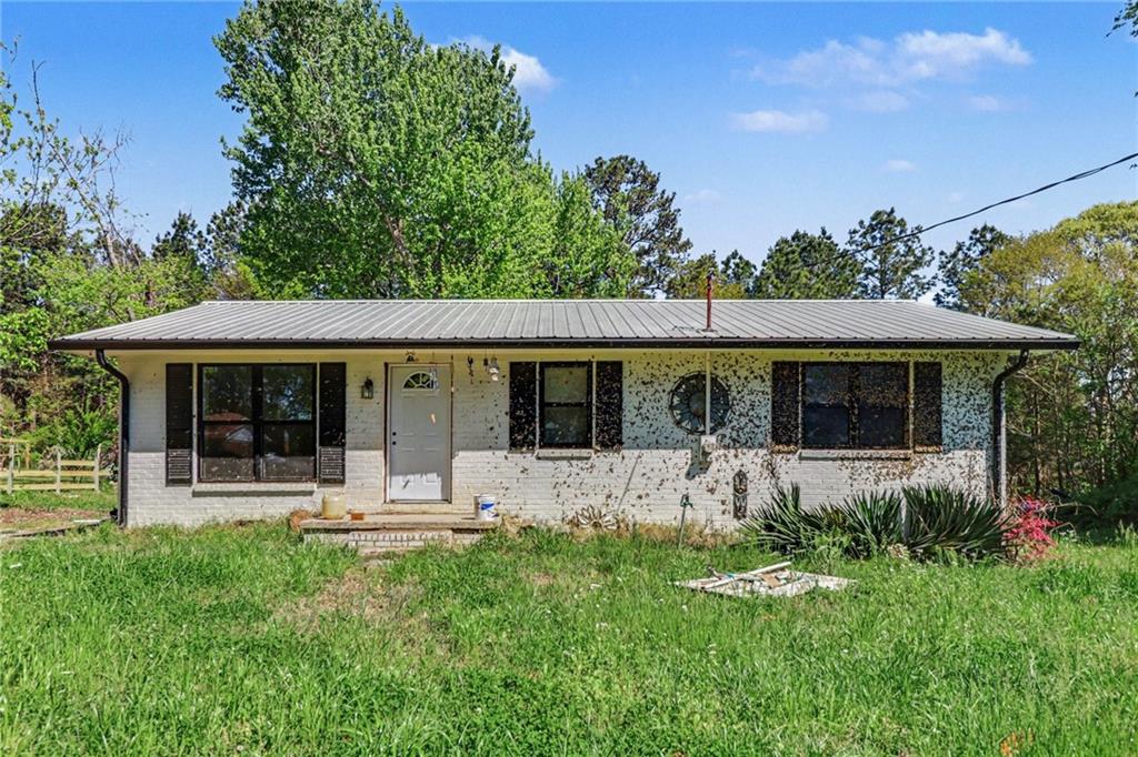 a front view of house with a garden and patio