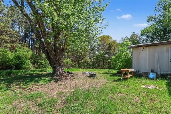 a backyard of a house with table and chairs