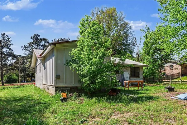 a view of a house with a yard and sitting area