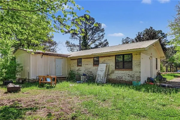 a backyard of a house with table and chairs