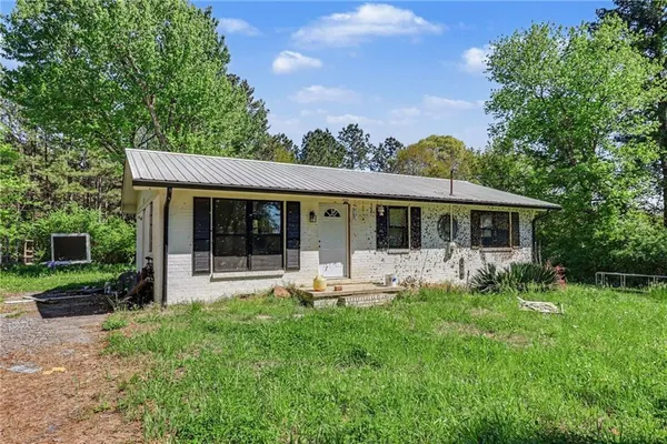a front view of house with a garden and patio