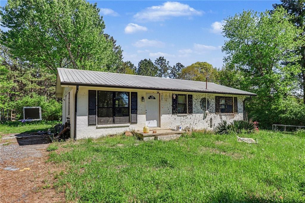 123 Baker Circle Southeast Calhoun, GA 30701 - Photo 3 of 15 a front view of house with a garden and patio