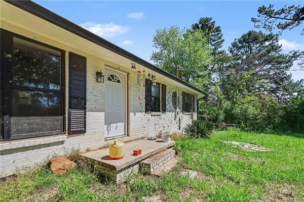 a backyard of a house with yard and outdoor seating