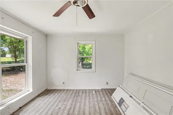 a view of room with window and wooden floor