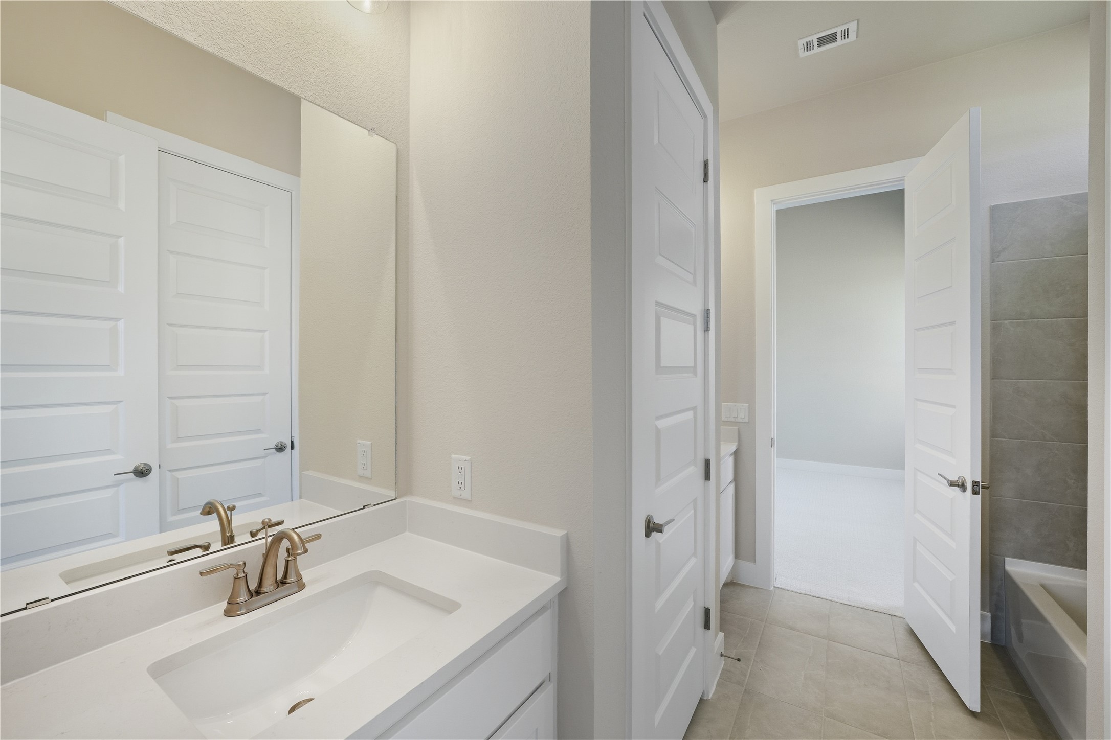 1209 Doelling Drive Georgetown, TX 78633 - Photo 23 of 31 Bathroom featuring vanity, light tile patterned flooring, and a bathtub