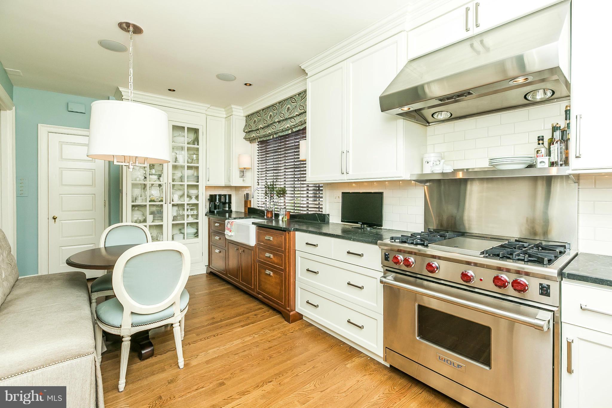 101 Upnor Road Baltimore, MD 21212 - Photo 14 of 30 a kitchen with a stove a sink and a wooden floor