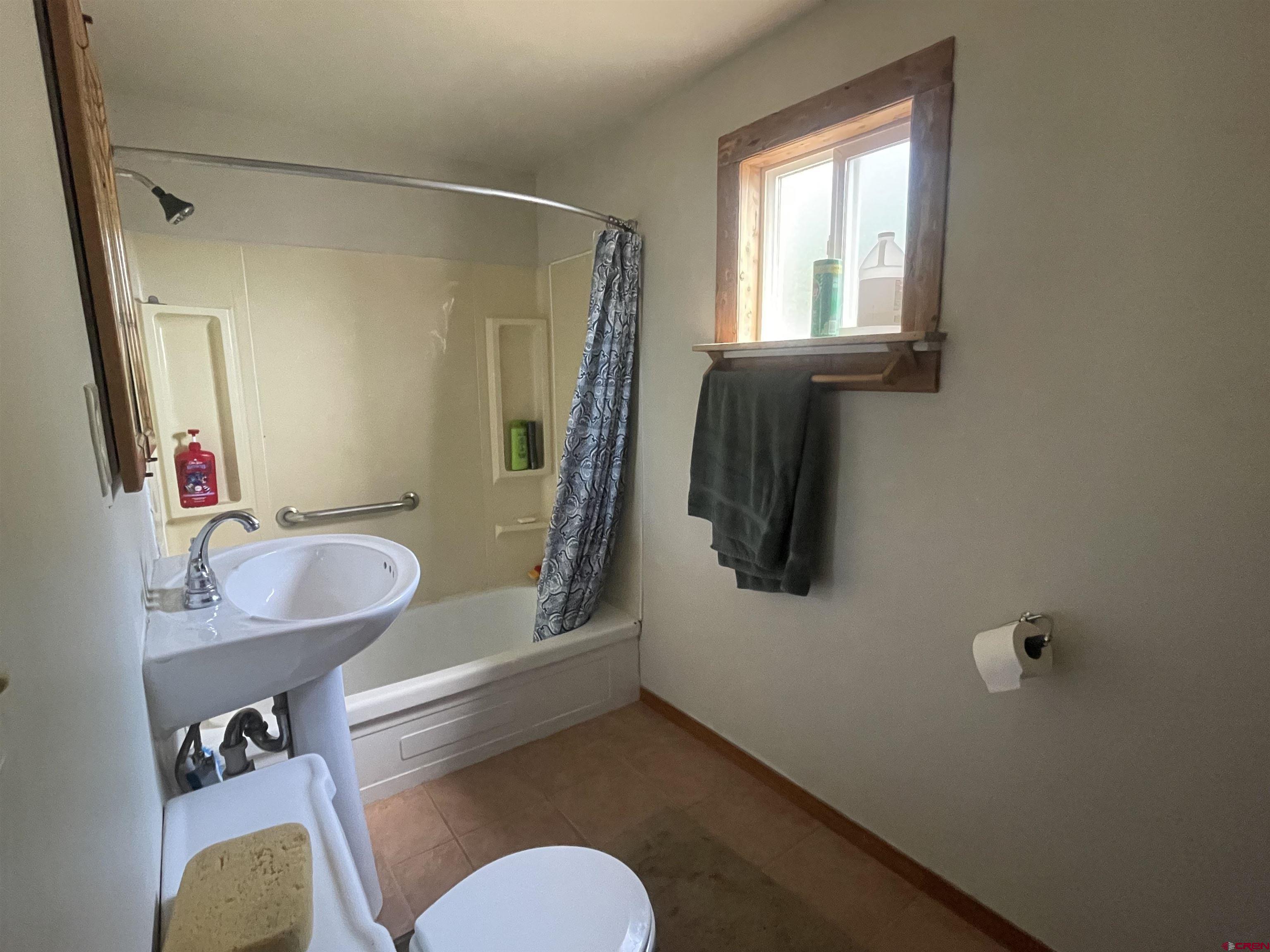 777 Stratton Drive Cortez, CO 81321 - Photo 11 of 16 a bathroom with a sink mirror toilet and bathtub