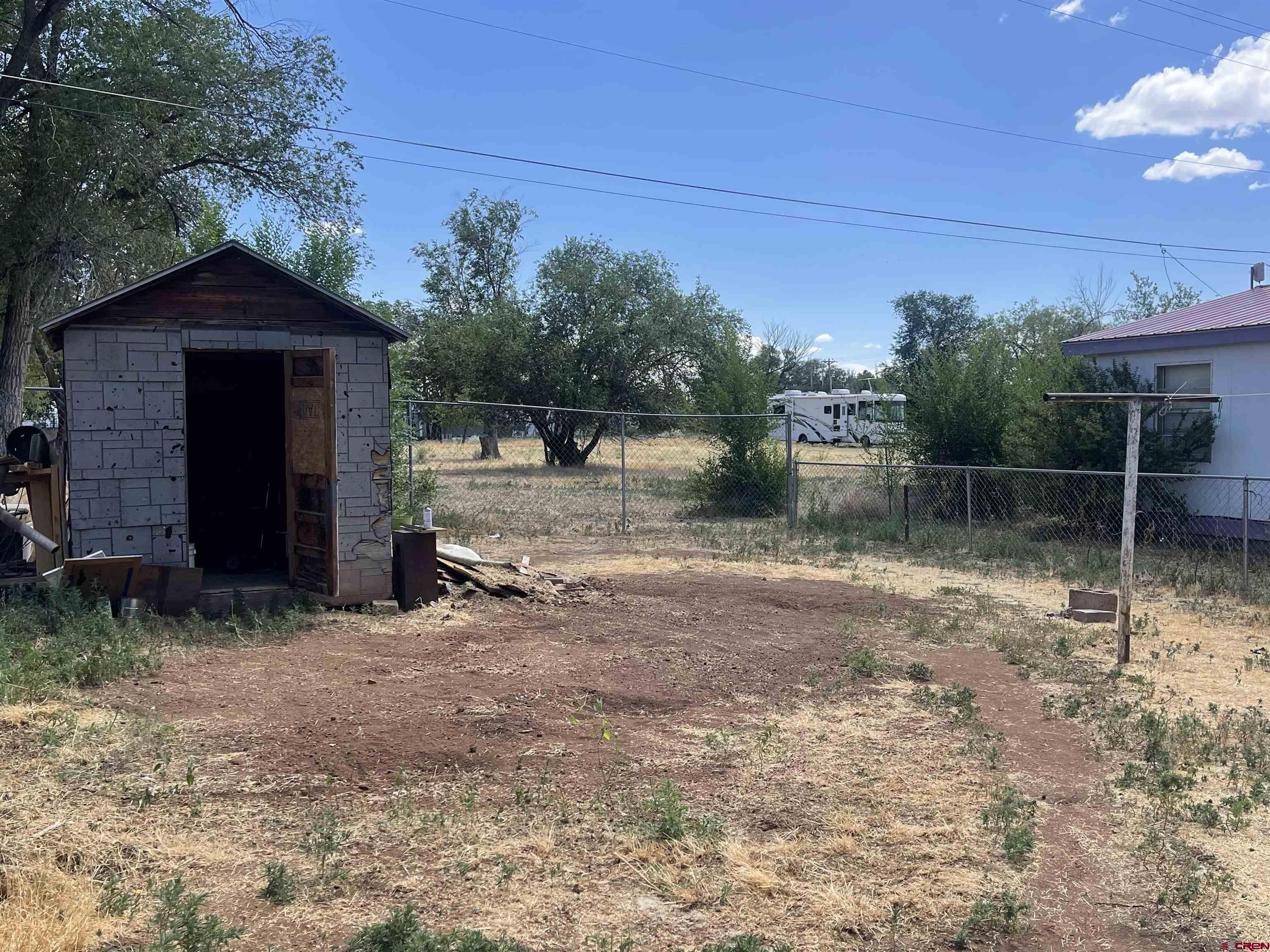 777 Stratton Drive Cortez, CO 81321 - Photo 13 of 16 a backyard of a house with lots of green space