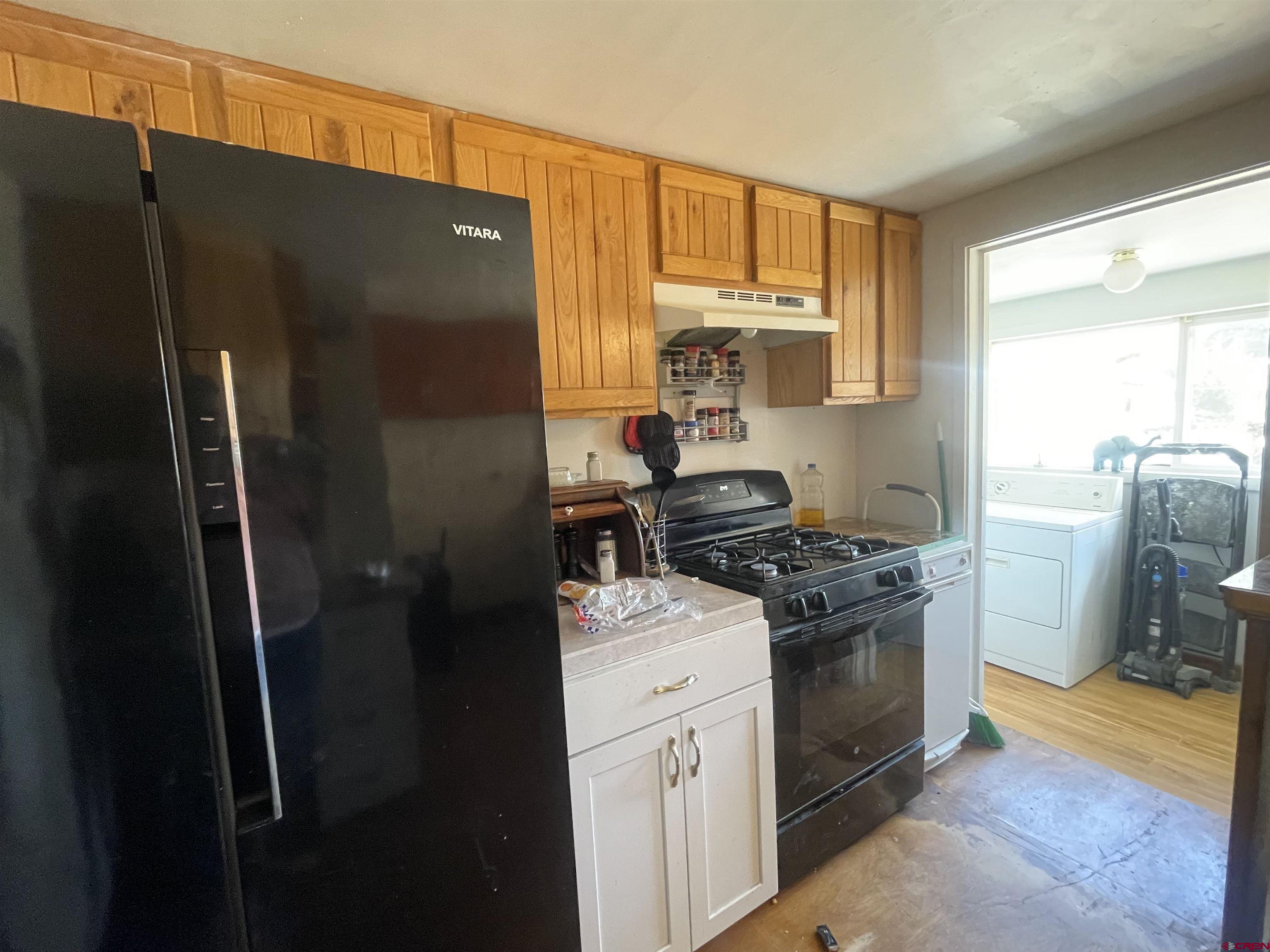 777 Stratton Drive Cortez, CO 81321 - Photo 3 of 16 a kitchen with a stove a refrigerator and a window