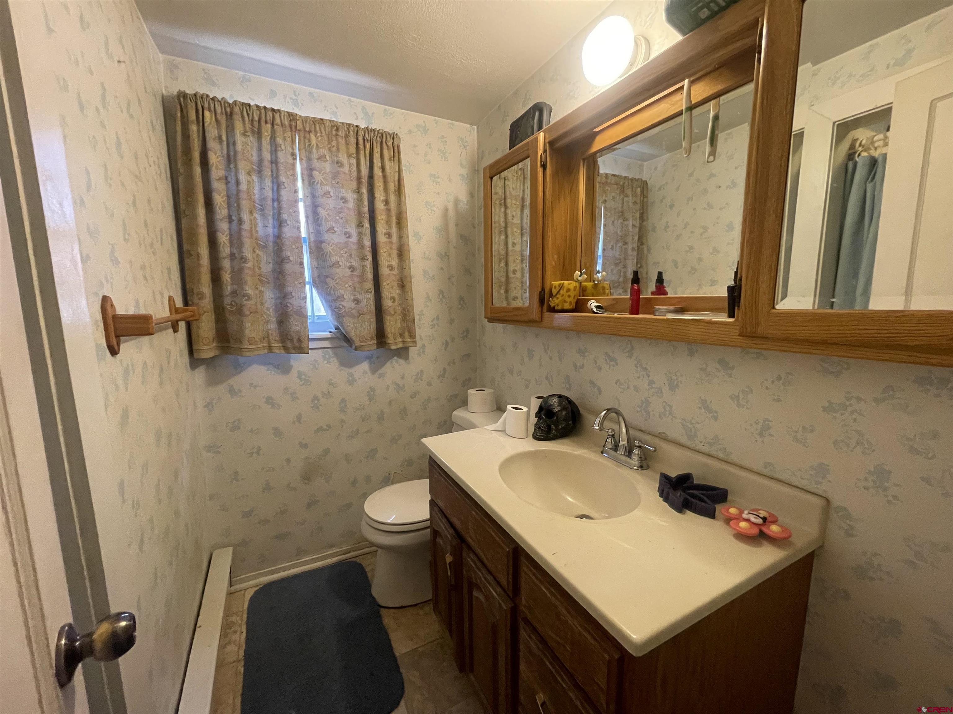 777 Stratton Drive Cortez, CO 81321 - Photo 10 of 16 a bathroom with a sink and a mirror