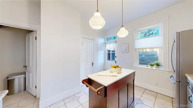a view of a kitchen area with furniture and wooden floor