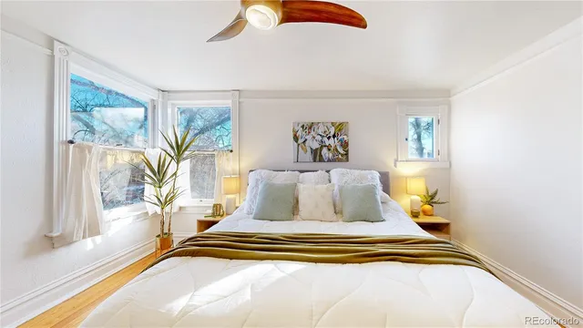 a bedroom with a bed and a large window