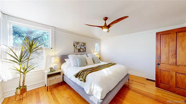 a bedroom with a bed and a painting on the wall