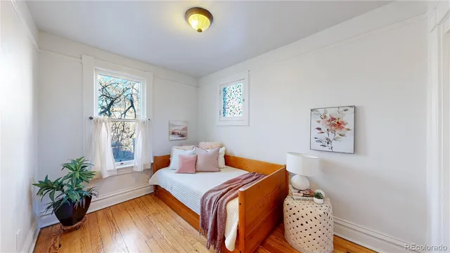 a bedroom with a bed and a potted plant