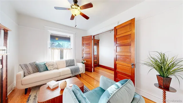 a living room with furniture and a potted plant