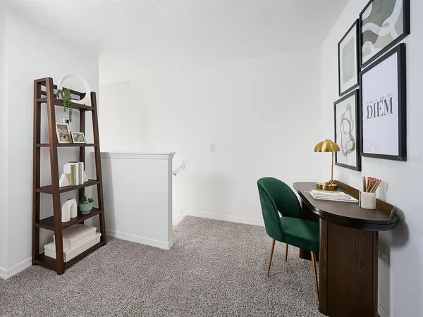 a view of a workspace with furniture and a window