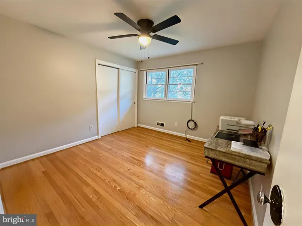 a workspace with furniture and view of wooden floor