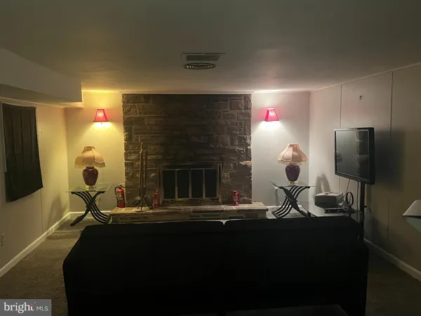 a living room with furniture a lamp and a fireplace