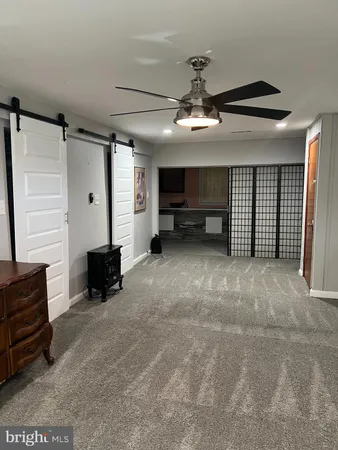 a view of a livingroom with furniture and a ceiling fan