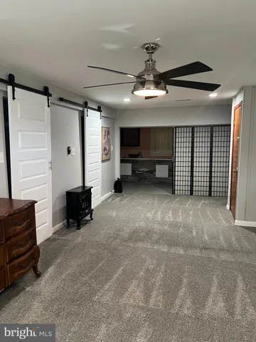 a view of a livingroom with furniture and a ceiling fan